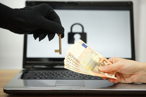 hand exchanging stack of money for a key held by a hand in a black glove