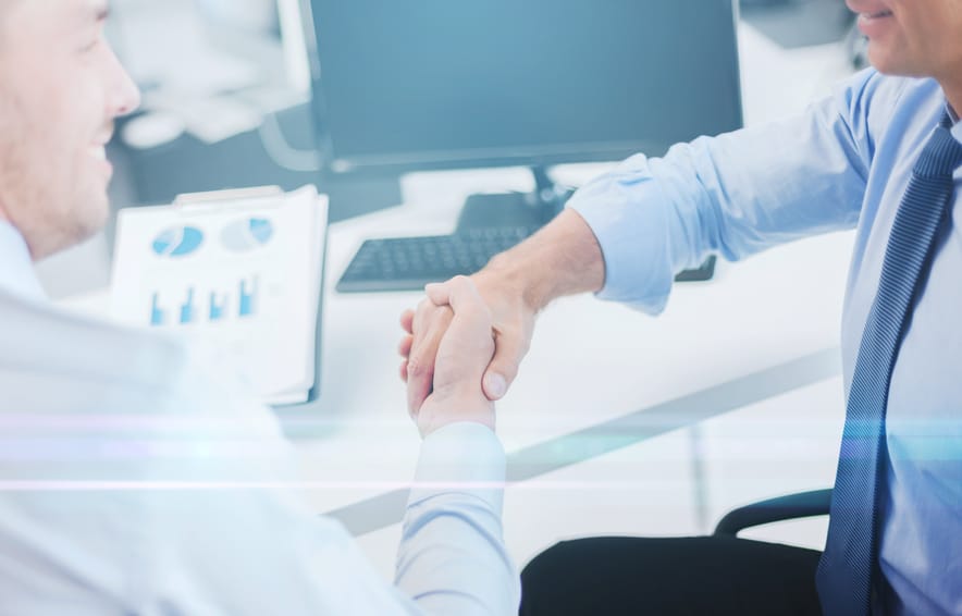 two businessmen shaking hands in office