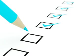 Checklist with blue pencil checking off boxes