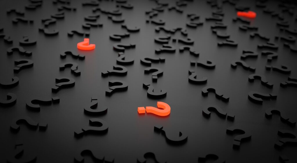 black background with 3d black question marks scattered across it and 3 orange 3d question marks among them