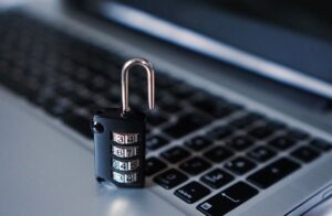combination lock open and sitting on top of a laptop keyboard