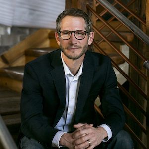 Applied Tech president daniel petersen sitting on stairs