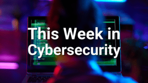 man sitting on front of computer screen displaying green code